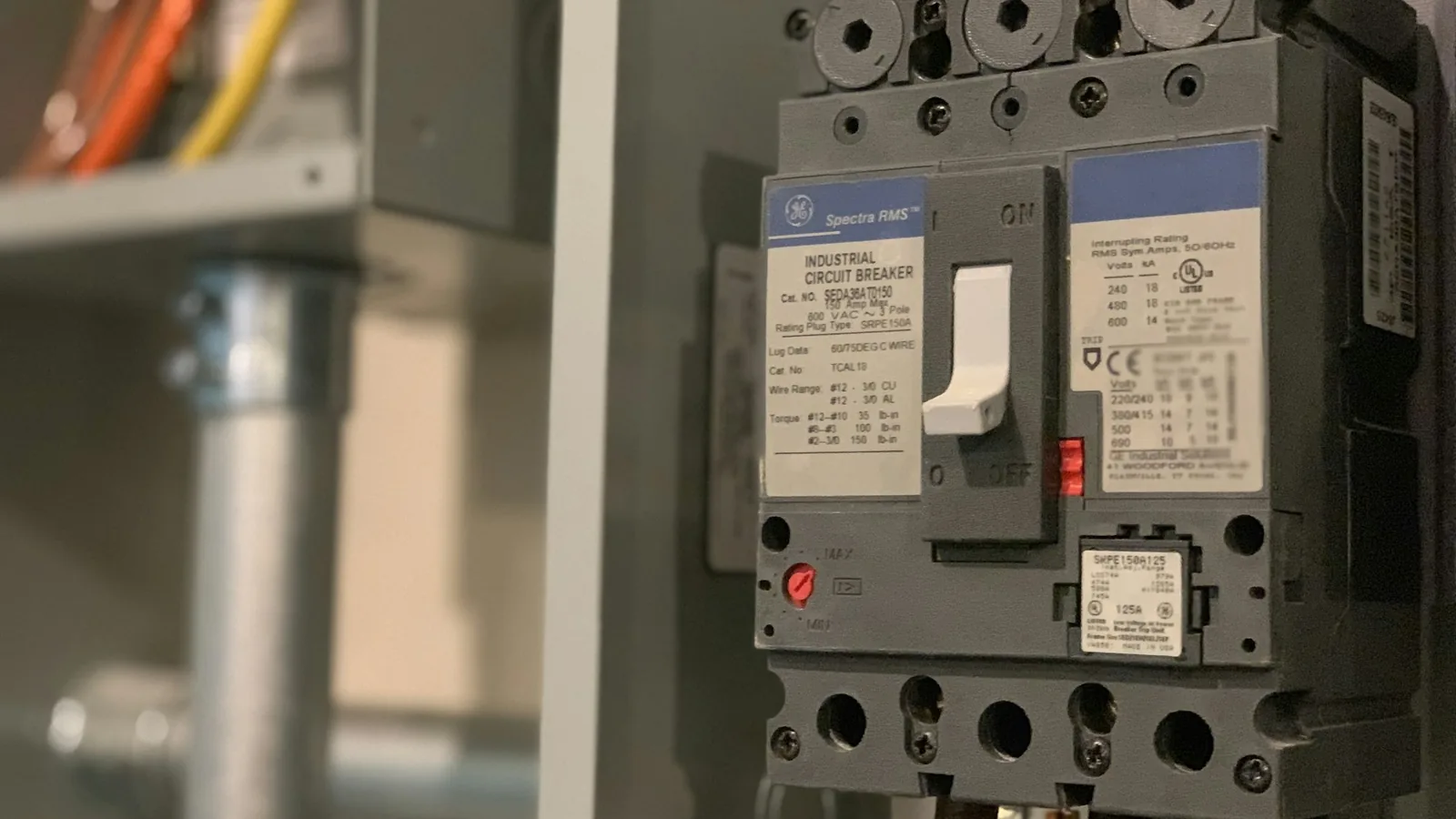 Molded-case circuit breaker inside an open industrial electrical panel