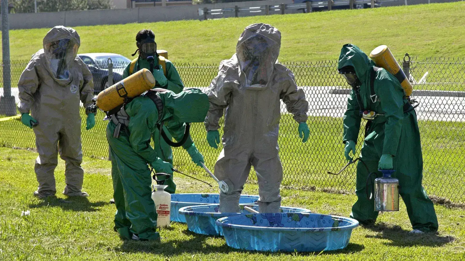 Responders in chemical protective suits practicing decontamination at a hazmat training exercise