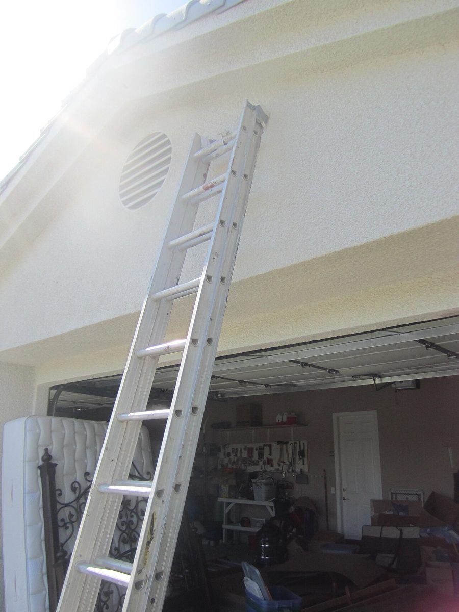 Aluminum extension ladder leaning against a building